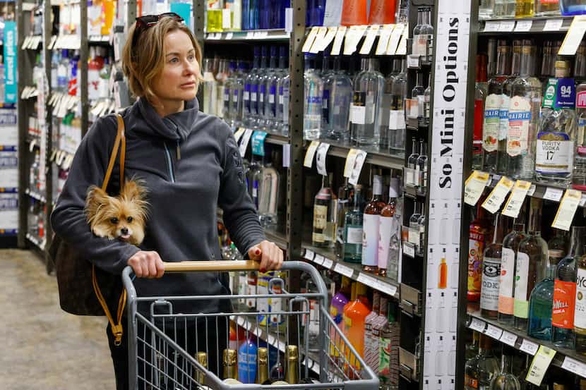 Gina Garcia, 52, shopped with her dog Nala at a Total Wine & More in Dallas on Dec. 17,...