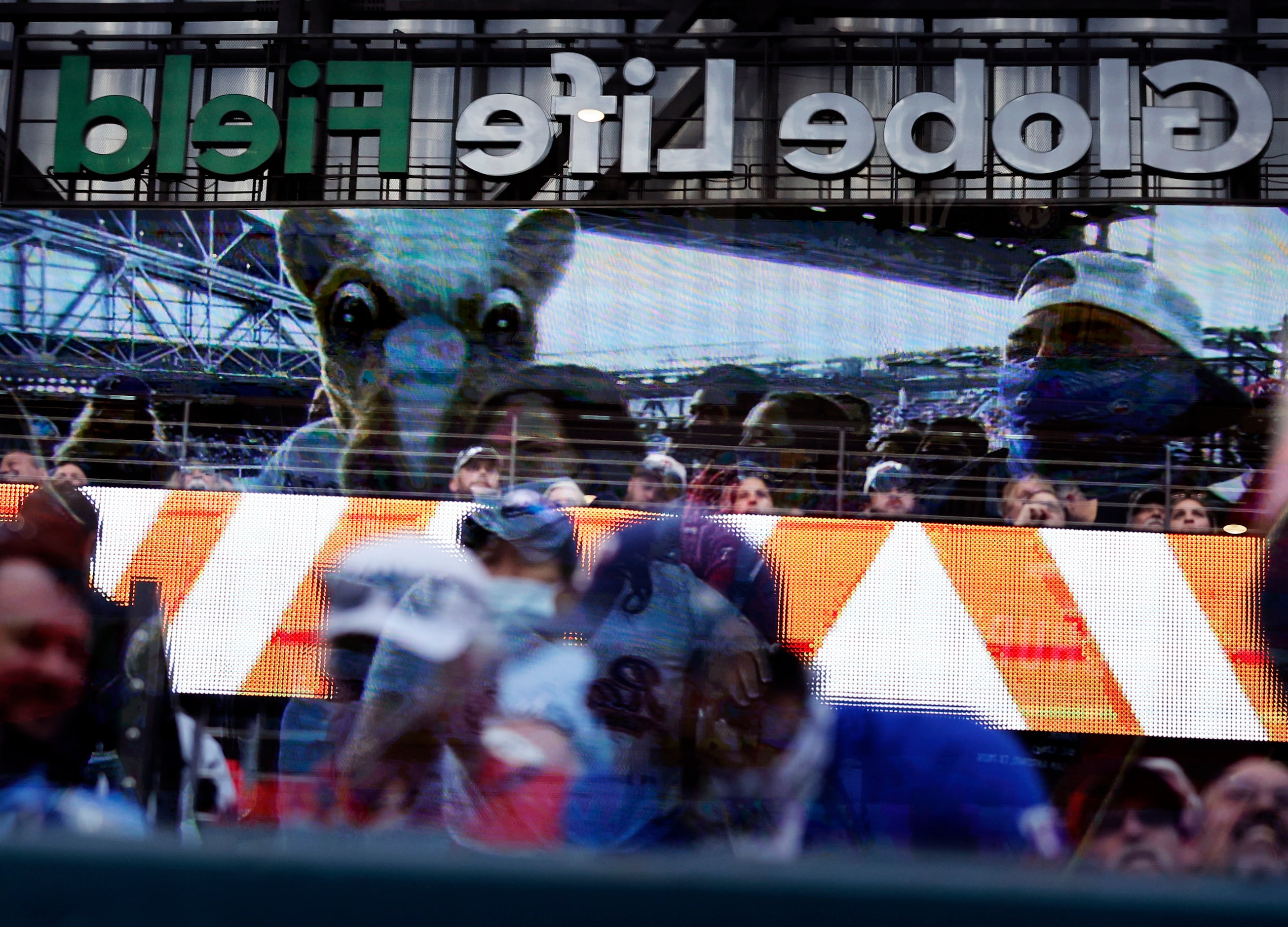 A reflection of the video board and stadium are seen in the plexiglass above the Toronto...