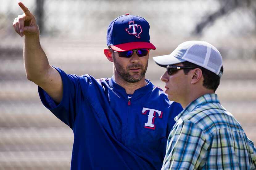FILE - Texas Rangers General Manager Jon Daniels (right) talks with former Rangers infielder...