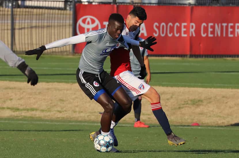Alfusainey Jatta of North Texas SC (in grey) fights off Ricardo Pepi playing for the FCD...