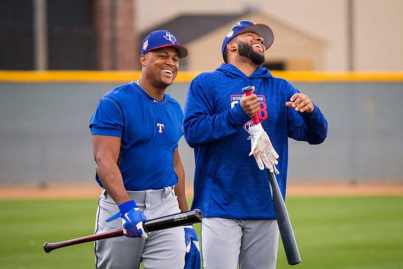 Texas Rangers third baseman Adrian Beltre (left) and shortstop Elvis Andrus laugh as they...