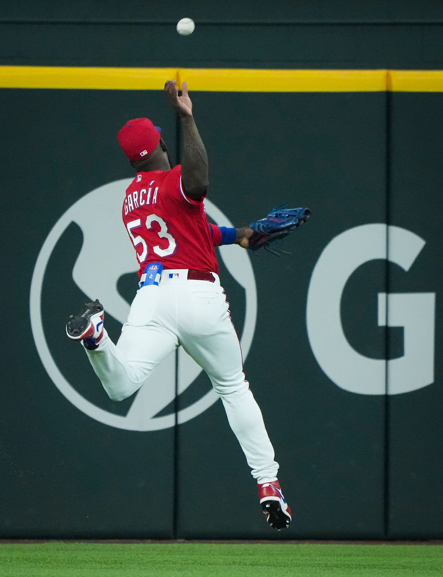 Texas Rangers center fielder Adolis Garcia can’t make the play on a double off the bat of...