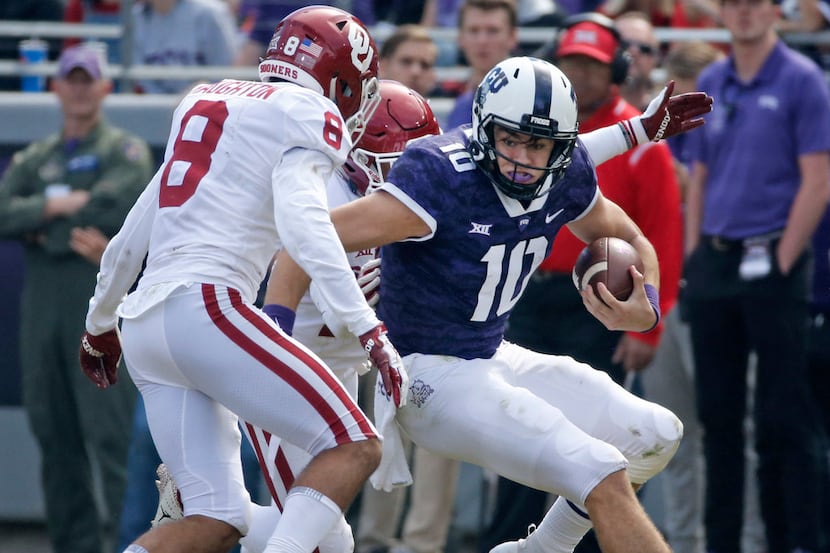 TCU Horned Frogs quarterback Michael Collins (10) looks for running room as Oklahoma Sooners...