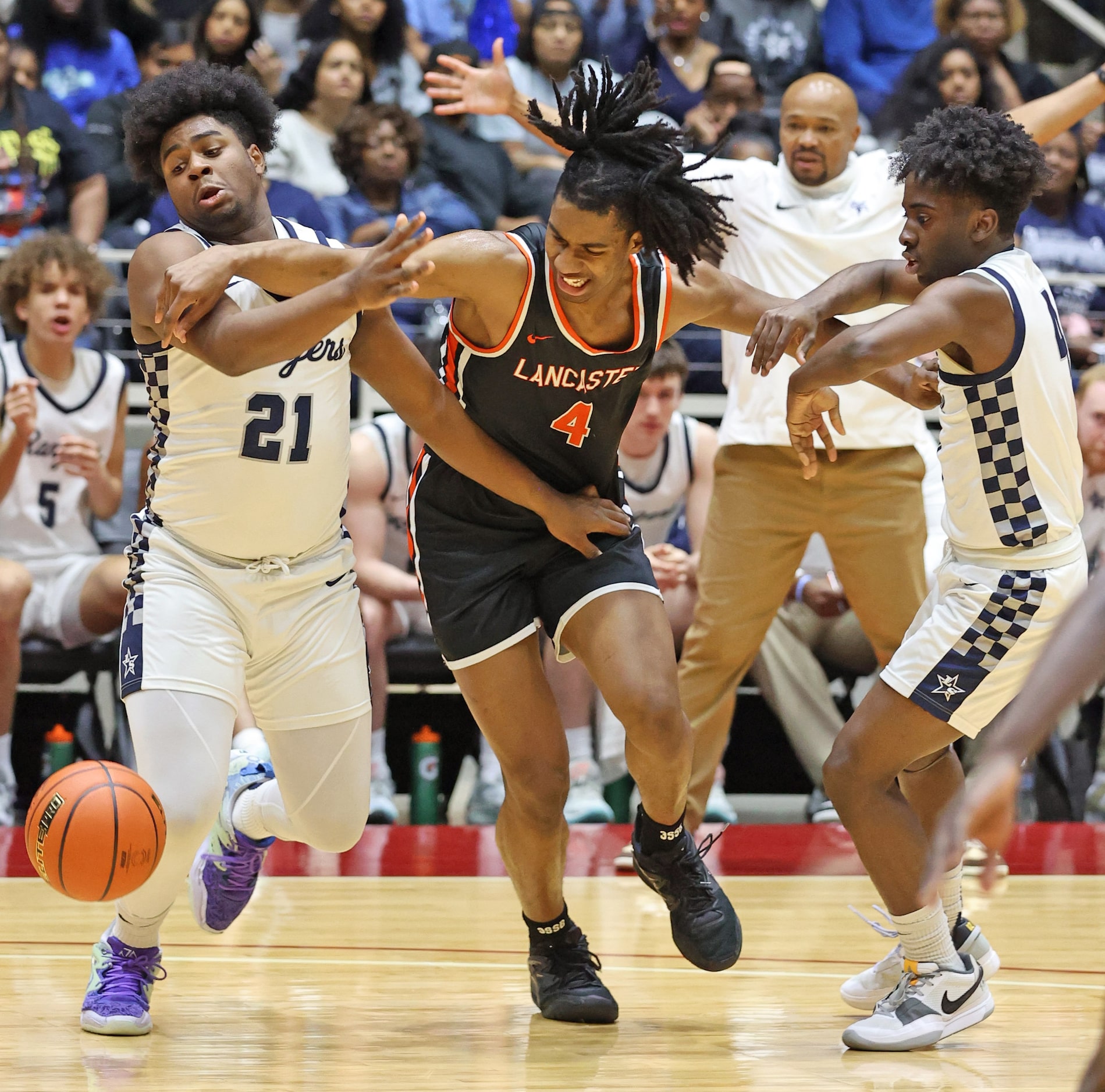 Lancaster's Dillon Battie (4) battles for a loose ball with Frisco Lone Star F Chris Knauls...