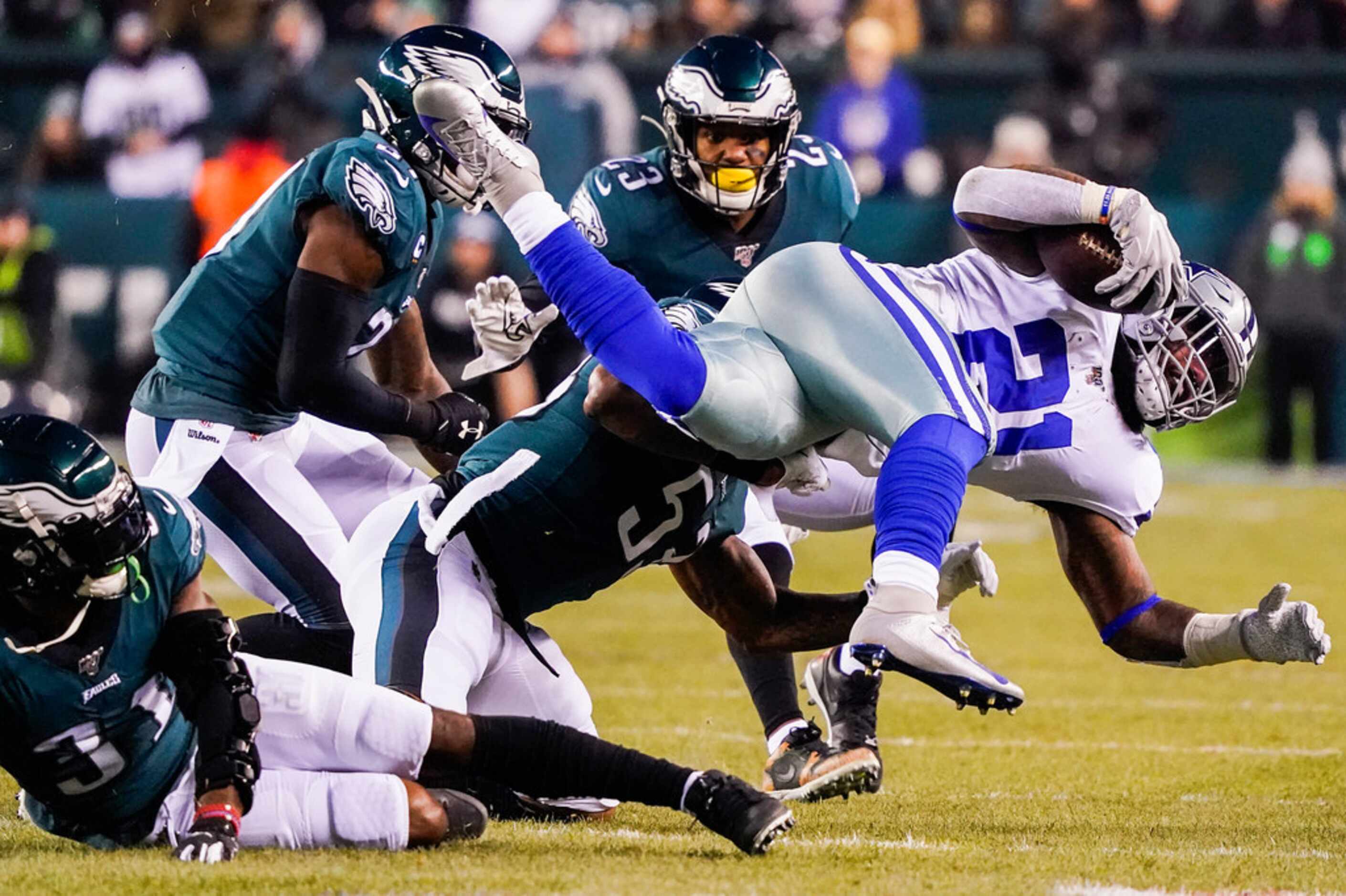 Dallas Cowboys running back Ezekiel Elliott (21) is upended by Philadelphia Eagles...