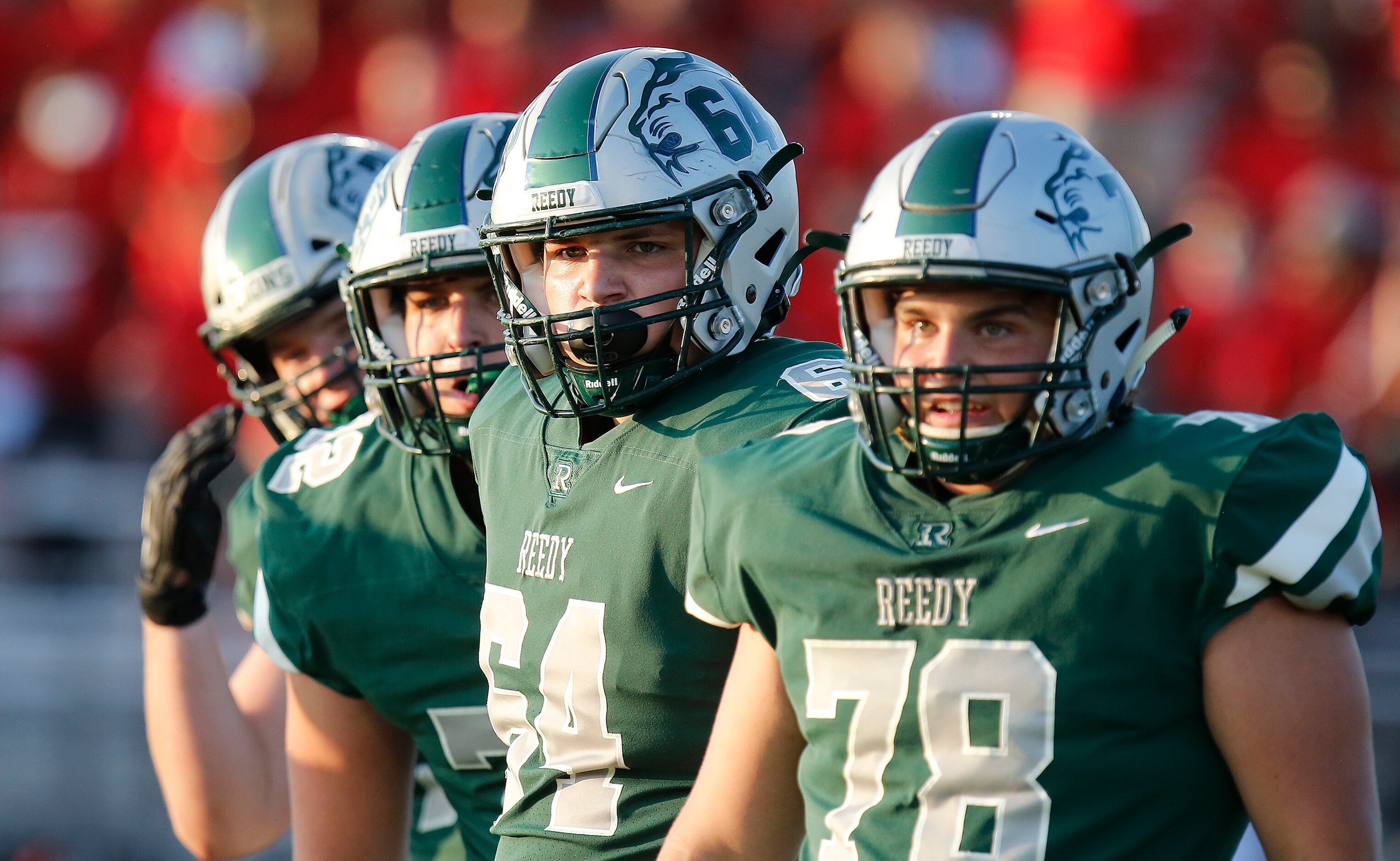 The Reedy High School offensive line looks to the sideline for signals from the coaches...