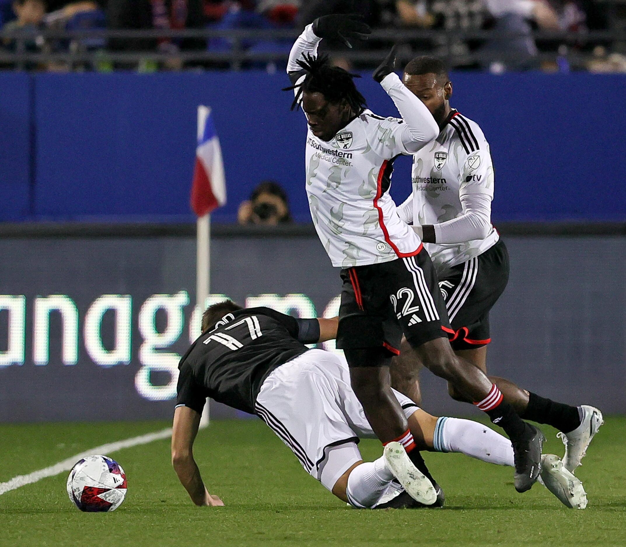 FC Dallas defender Ema Twumasi (22) tries to avoid Minnesota United midfielder Robin Lod...