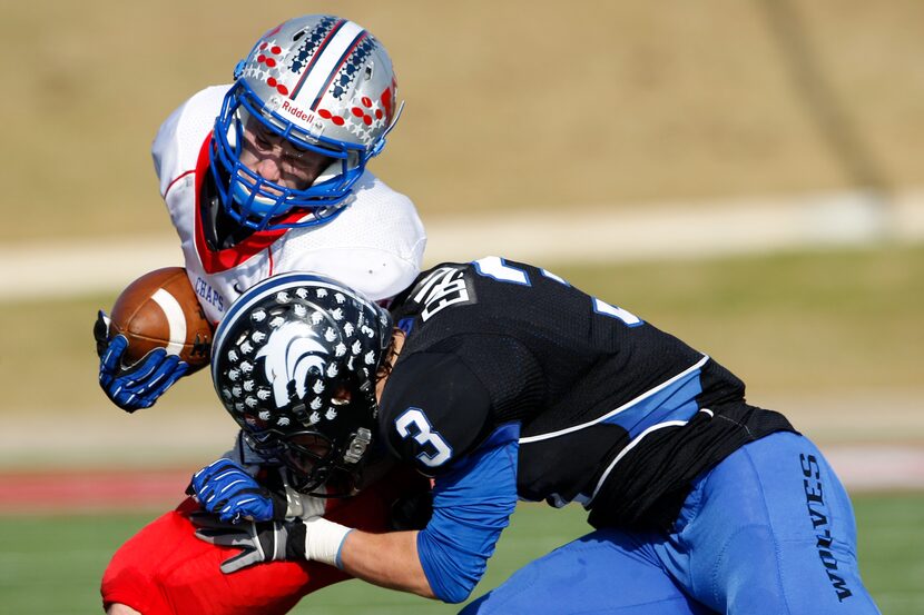 Austin Westlake's Sean Rollings (11) is tackled by Plano West's Collin Eberle (3) in the...