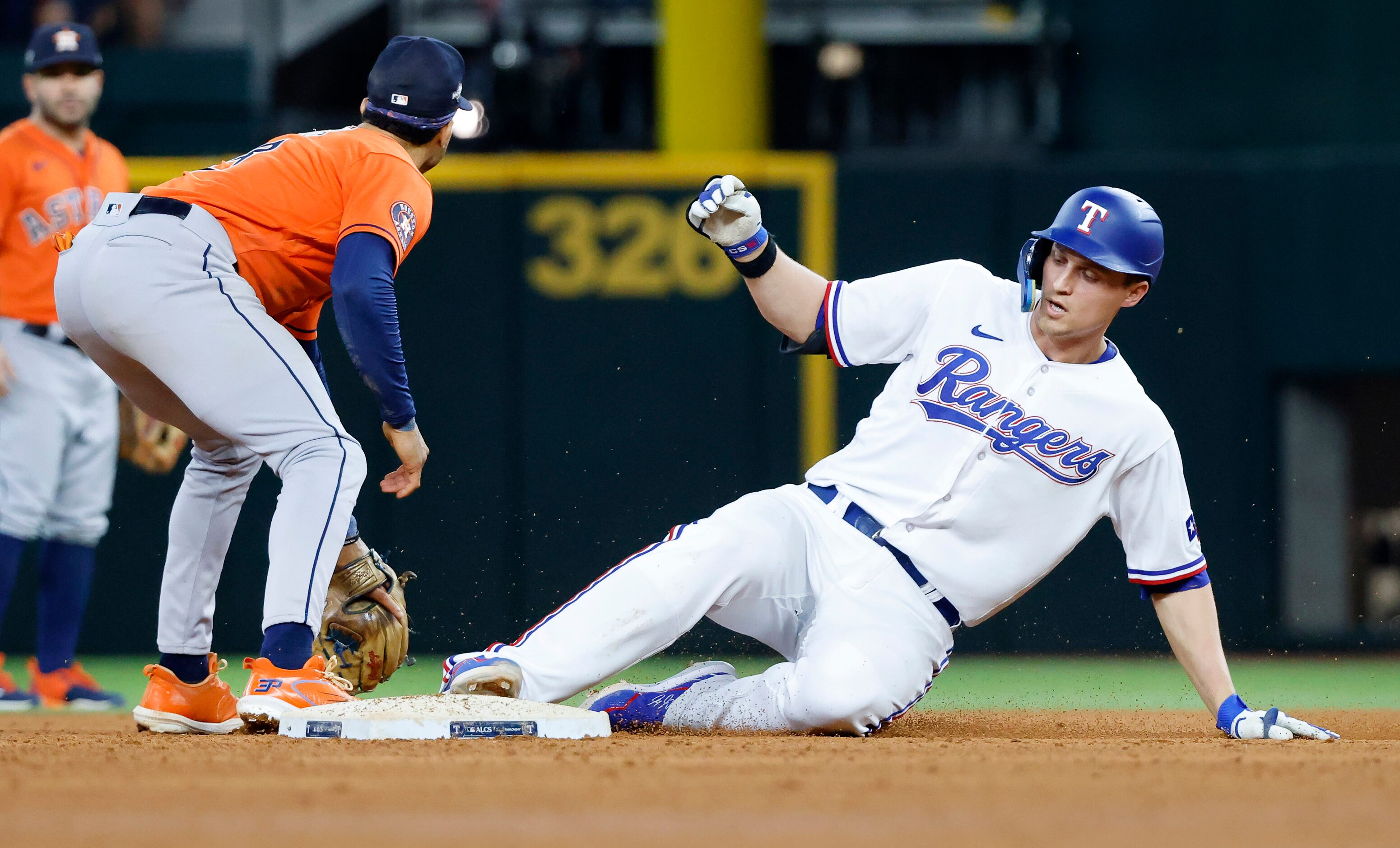 Texas Rangers shortstop Corey Seager (5) slides safely into second on a sixth inning double...