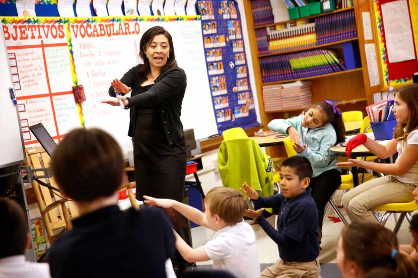 Harry C. Withers Elementary School teacher Irma De La Guardia leads third graders in a dual...