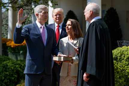 President Donald Trump watches as Supreme Court Justice Anthony Kennedy administers the...