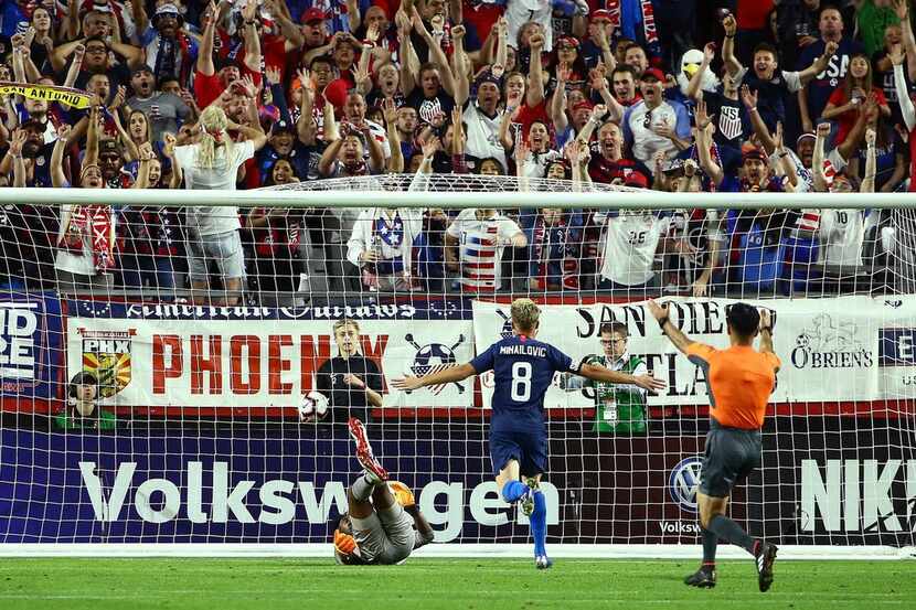 United States midfielder Djordje Mihailovic (8) scores a goal against Panama goalkeeper...
