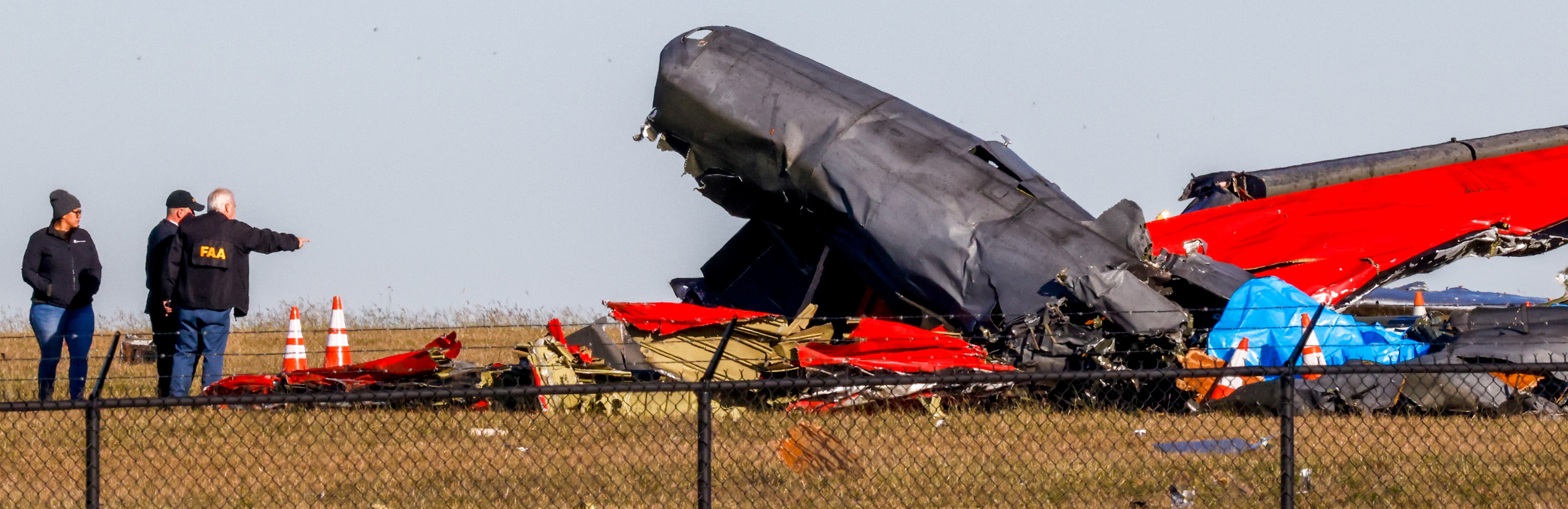 Officials, including those from the Federal Aviation Administration, survey damage from a...