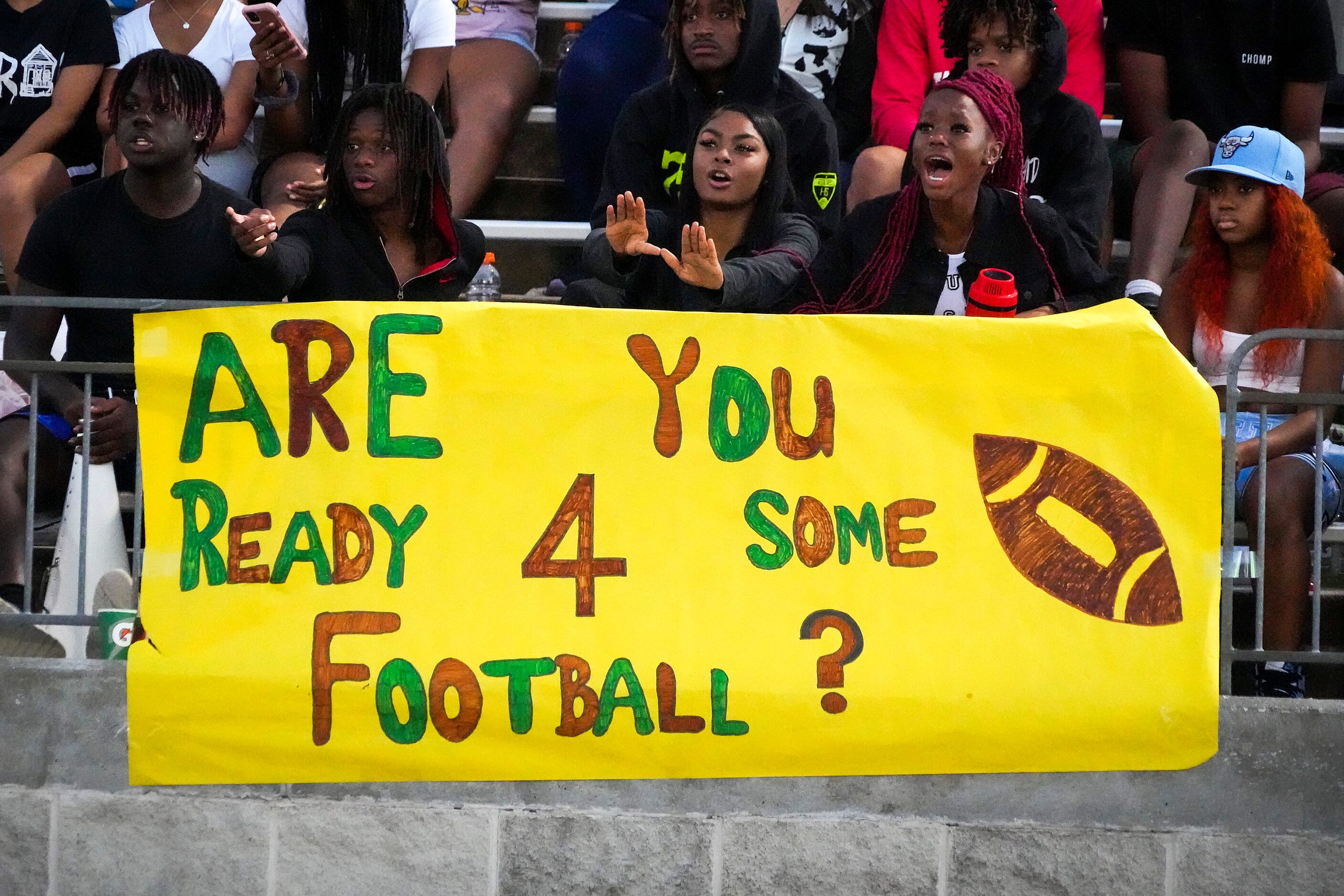 DeSoto fans watch their team face Waxahachie during the first half of a high school football...