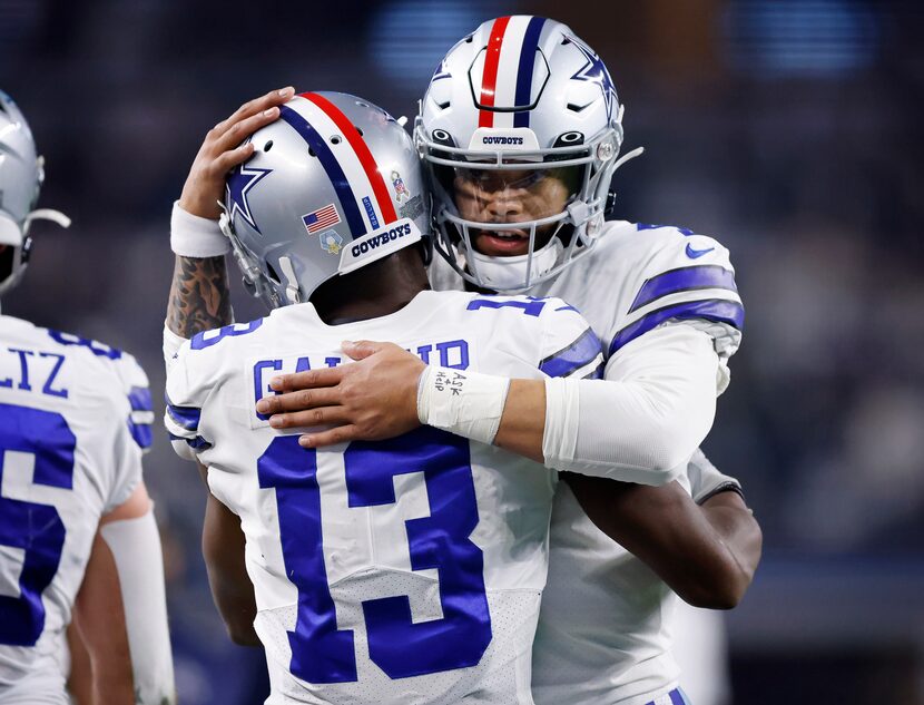 Dallas Cowboys quarterback Dak Prescott (4) congratulates wide receiver Michael Gallup (13)...