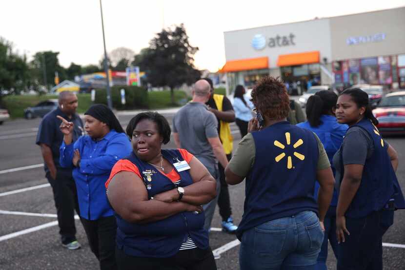 Walmart employees gather in the parking lot after a reported shooting at a store in Wyncote,...