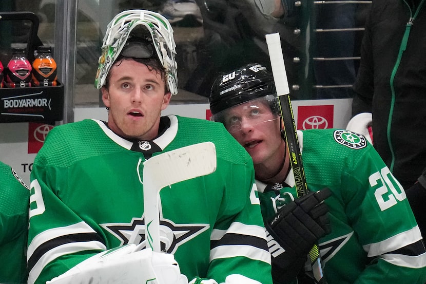 Dallas Stars goaltender Jake Oettinger (29) watches from the bench with defenseman Ryan...