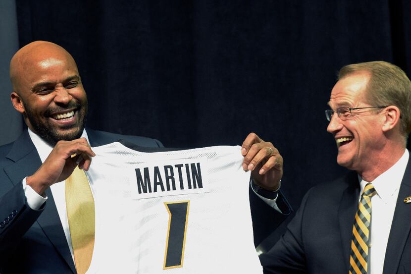 Cuonzo Martin, left, and athletic director Jim Sterk laugh as Martin receives a personalized...