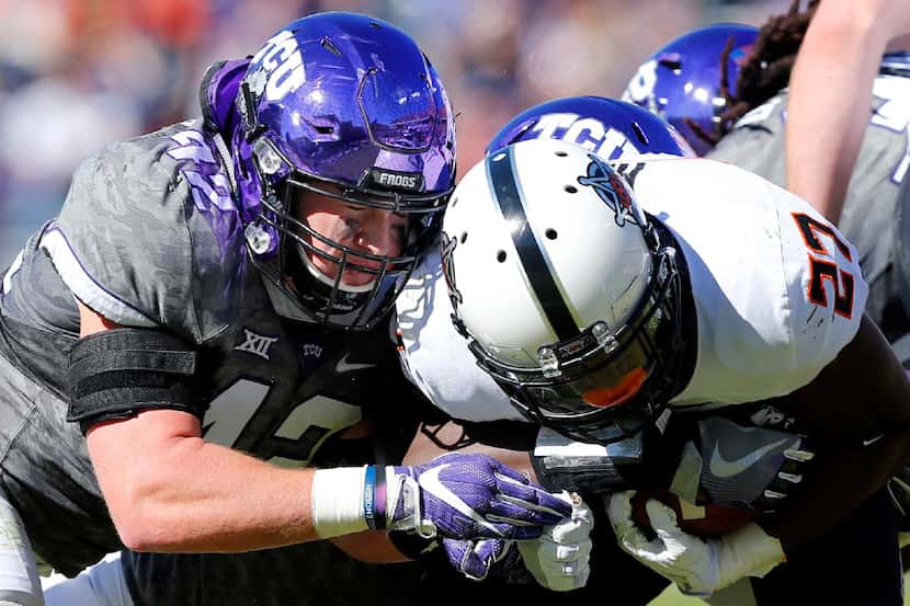 TCU Horned Frogs linebacker Ty Summers (42) puts the hit Oklahoma State Cowboys running back...