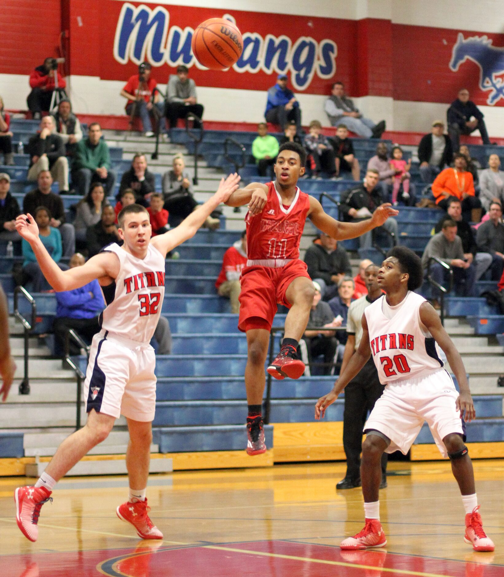 Woodrow Wilson guard Craig Martin (11) delivers a flying cross court pass to a teammate...