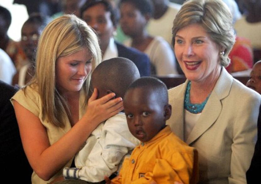 Laura Bush, with daughter Jenna and Rwandan children in Kigali, went on an official visit to...
