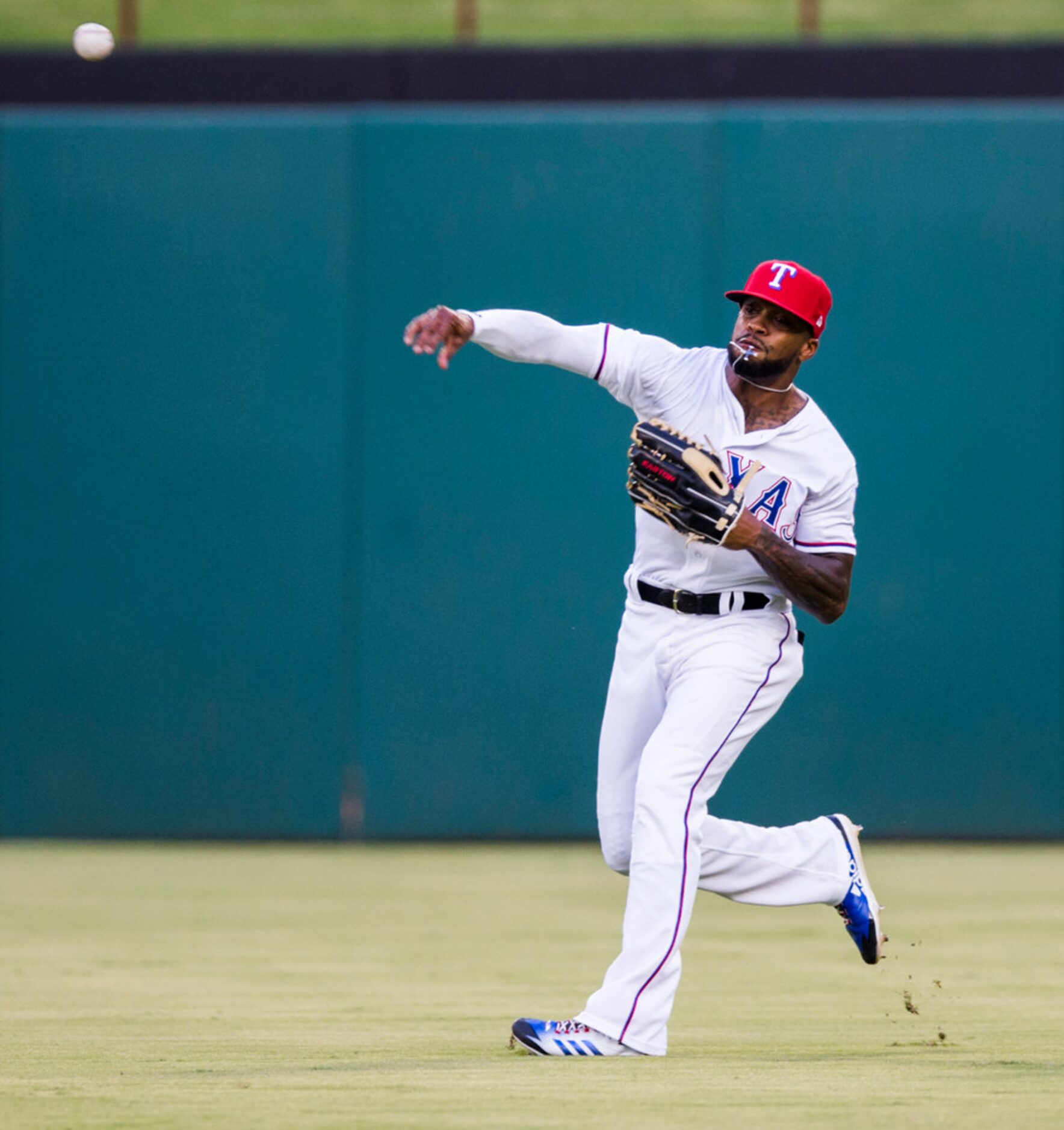 Texas Rangers center fielder Delino DeShields (3) throws in a ball from the outfield during...