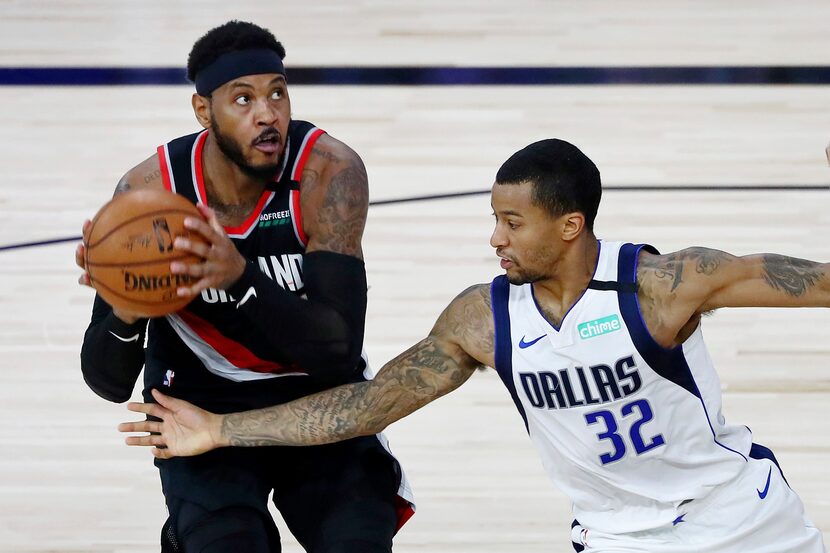 Portland Trail Blazers forward Carmelo Anthony (00) holds the ball as Dallas Mavericks guard...