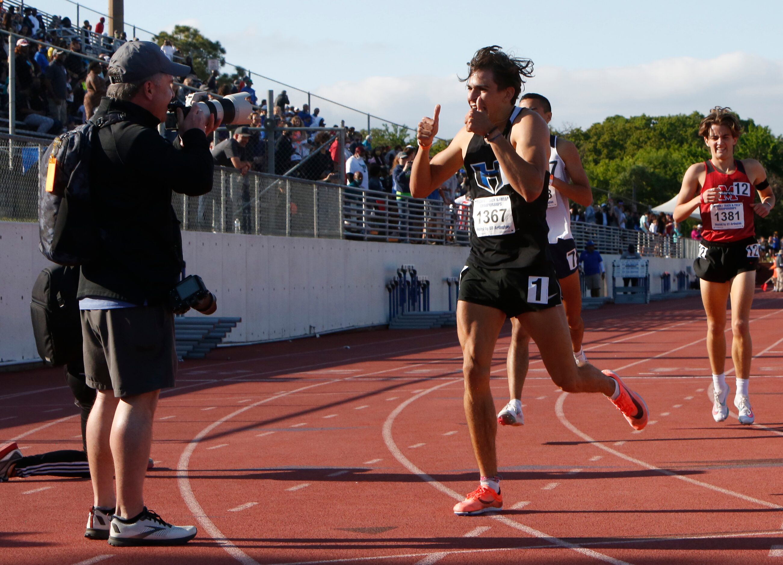 Hebron's Isaac Barrera gives the "thumbs up" sign for a photographer after winning the Class...