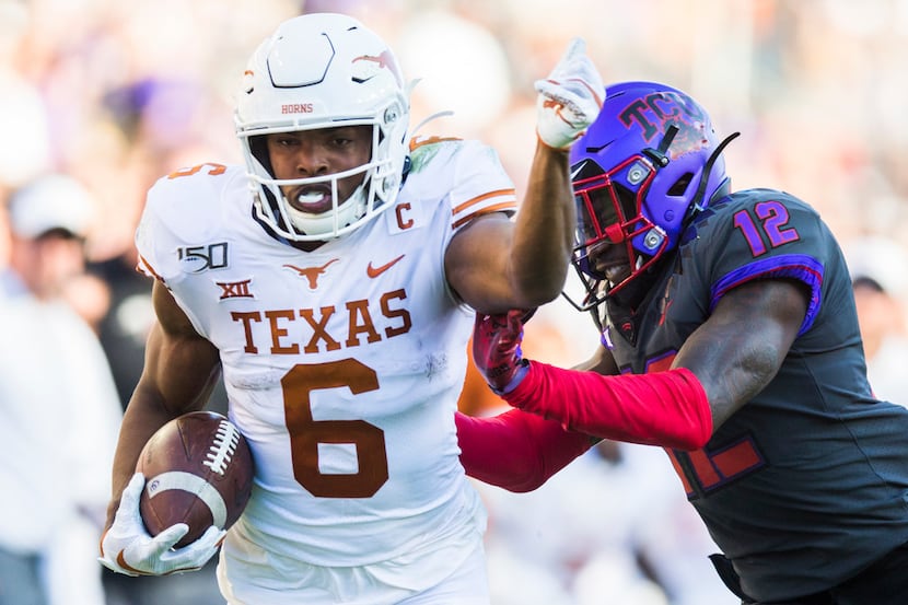 Texas Longhorns wide receiver Devin Duvernay (6) is pushed out of bounds by TCU Horned Frogs...
