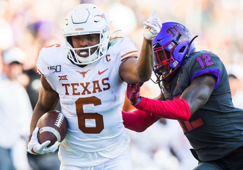 Texas Longhorns wide receiver Devin Duvernay (6) is pushed out of bounds by TCU Horned Frogs...