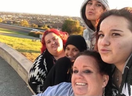 Cherish Gibson, far right, pictured with mother Stacy Hernandez (bottom) and sisters, from...