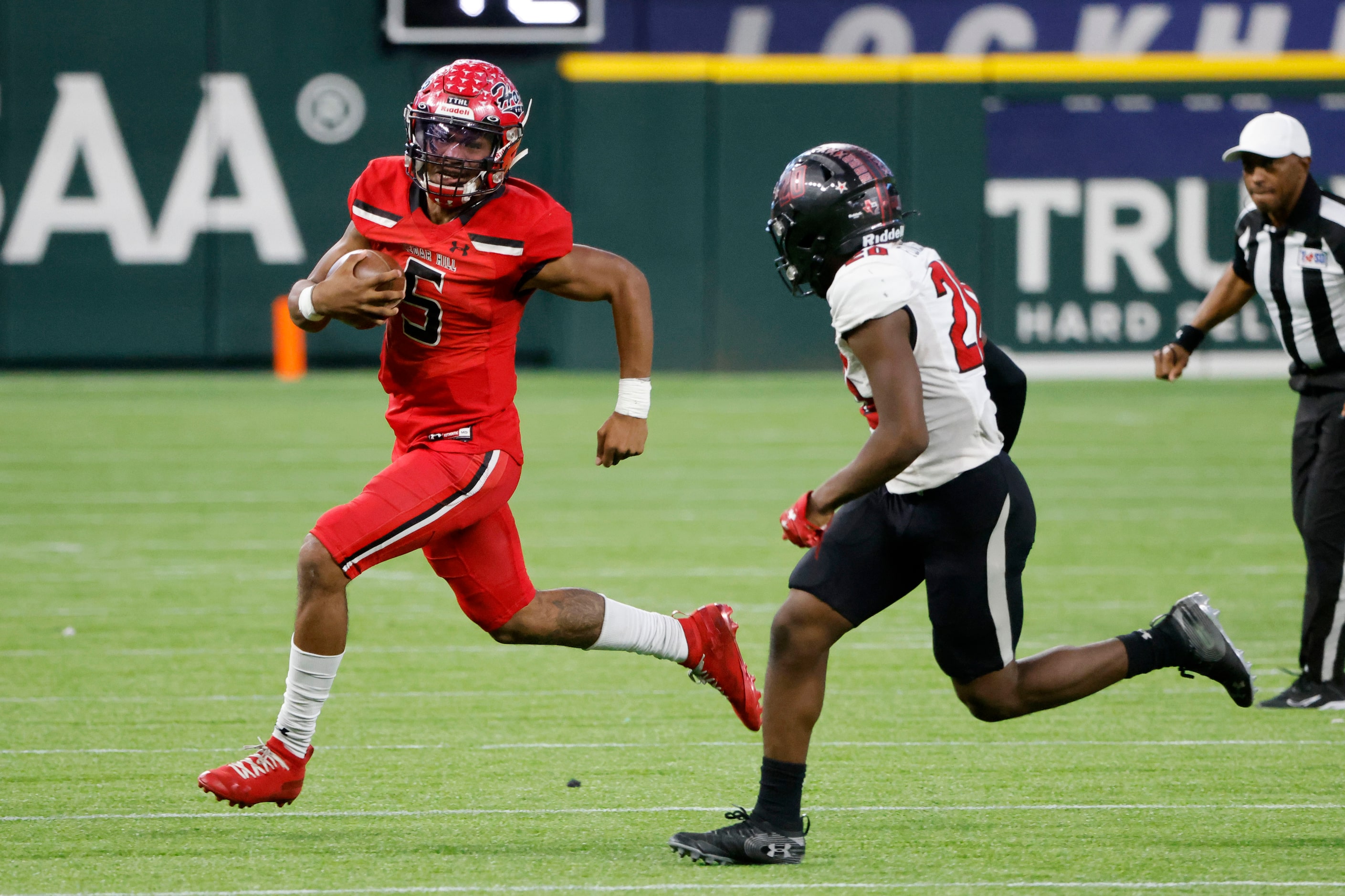 Cedar Hill quarterback Cedric Harden Jr. tries to get away from Tyler Legacy defender...