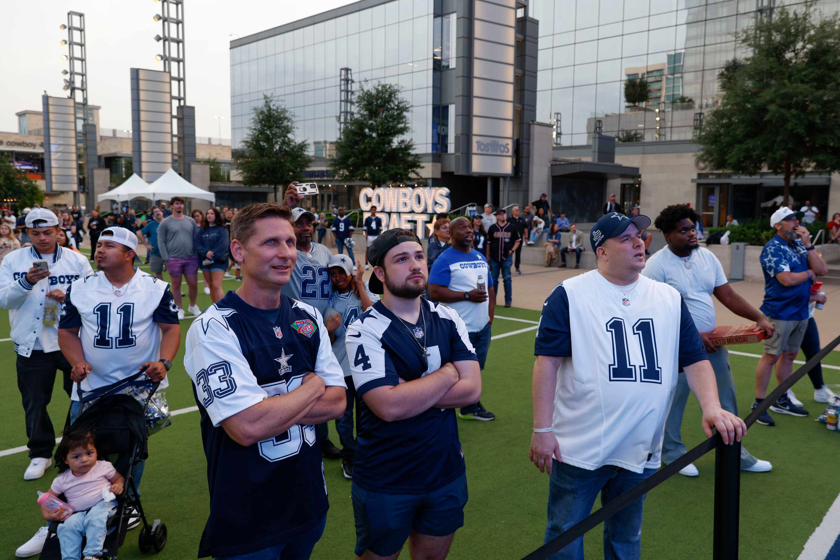 Dallas Cowboys fans look towards the big screen as they wait for the Cowboys’ 56th pick in...