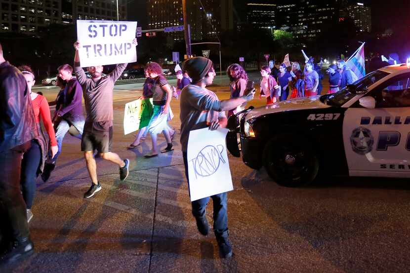 Protesters against President-elect Donald Trump march in downtown Dallas.