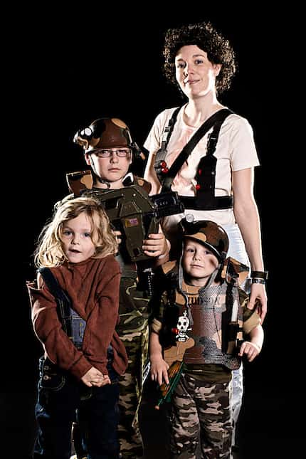 Keely Graesser poses with her children, Sarah, 6, Peter, 8, and Luke, 4, as characters from...