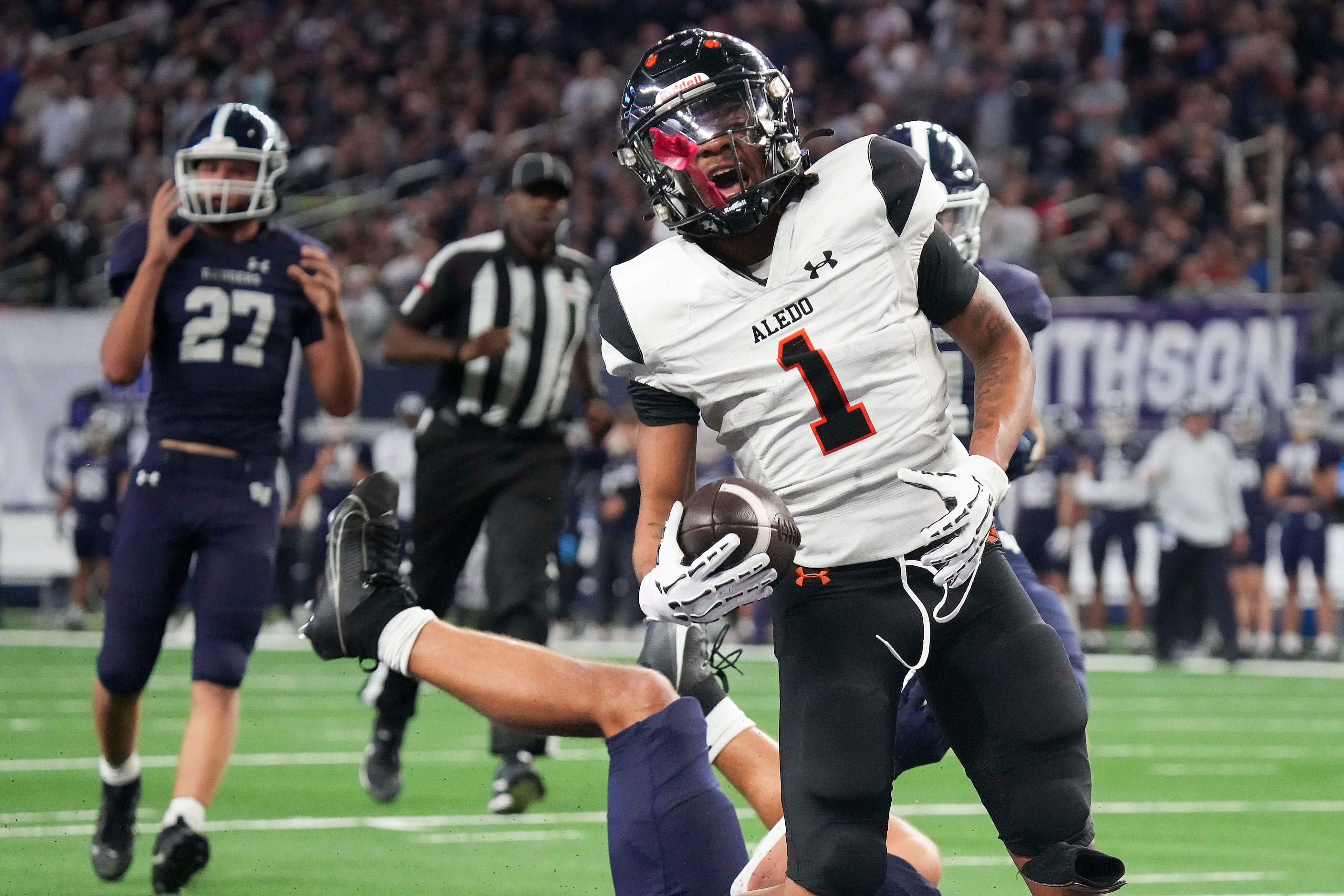 Aledo's Hawk Patrick-Daniels (1) breaks through the Comal Smithson Valley defense on a...