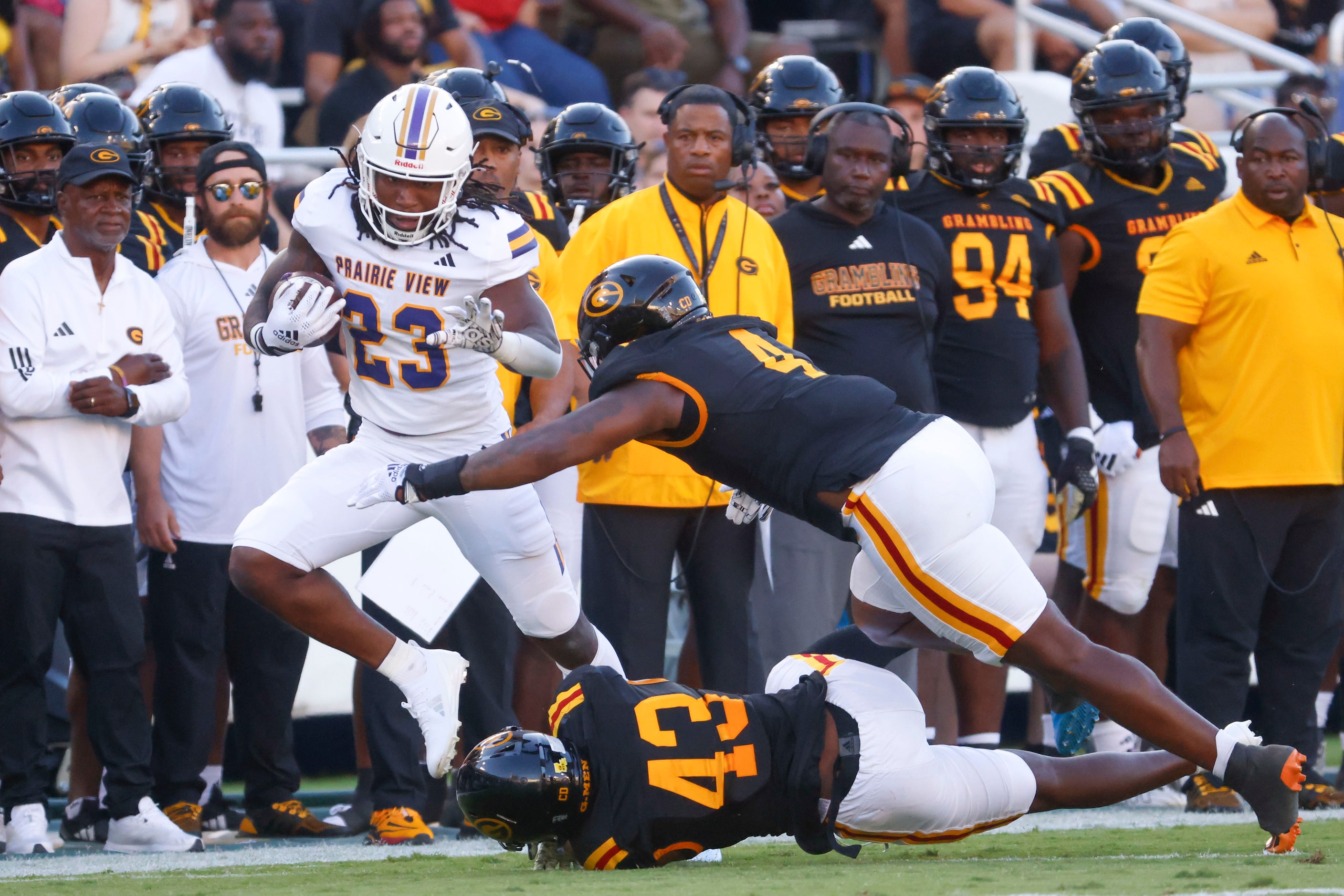 Prairie View A&M running back Lamagea McDowell (left) avoids being tackled by Grambling...