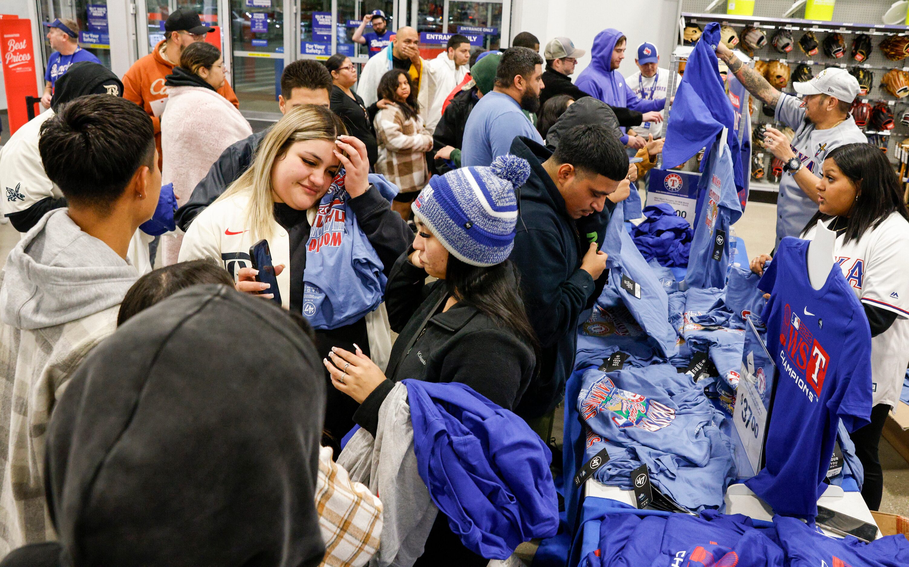 People shop for Texas Rangers World Series championship merchandise at an Academy Sports,...