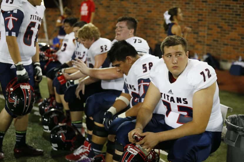 Trace Ellison sits on the sideline after an injury in the first quarter of the...
