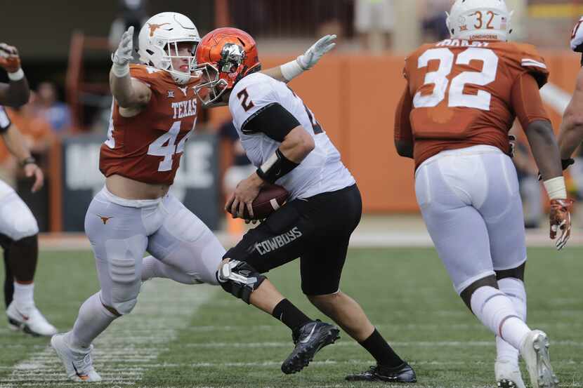 AUSTIN, TX - OCTOBER 21:  Breckyn Hager #44 of the Texas Longhorns pressures Mason Rudolph...