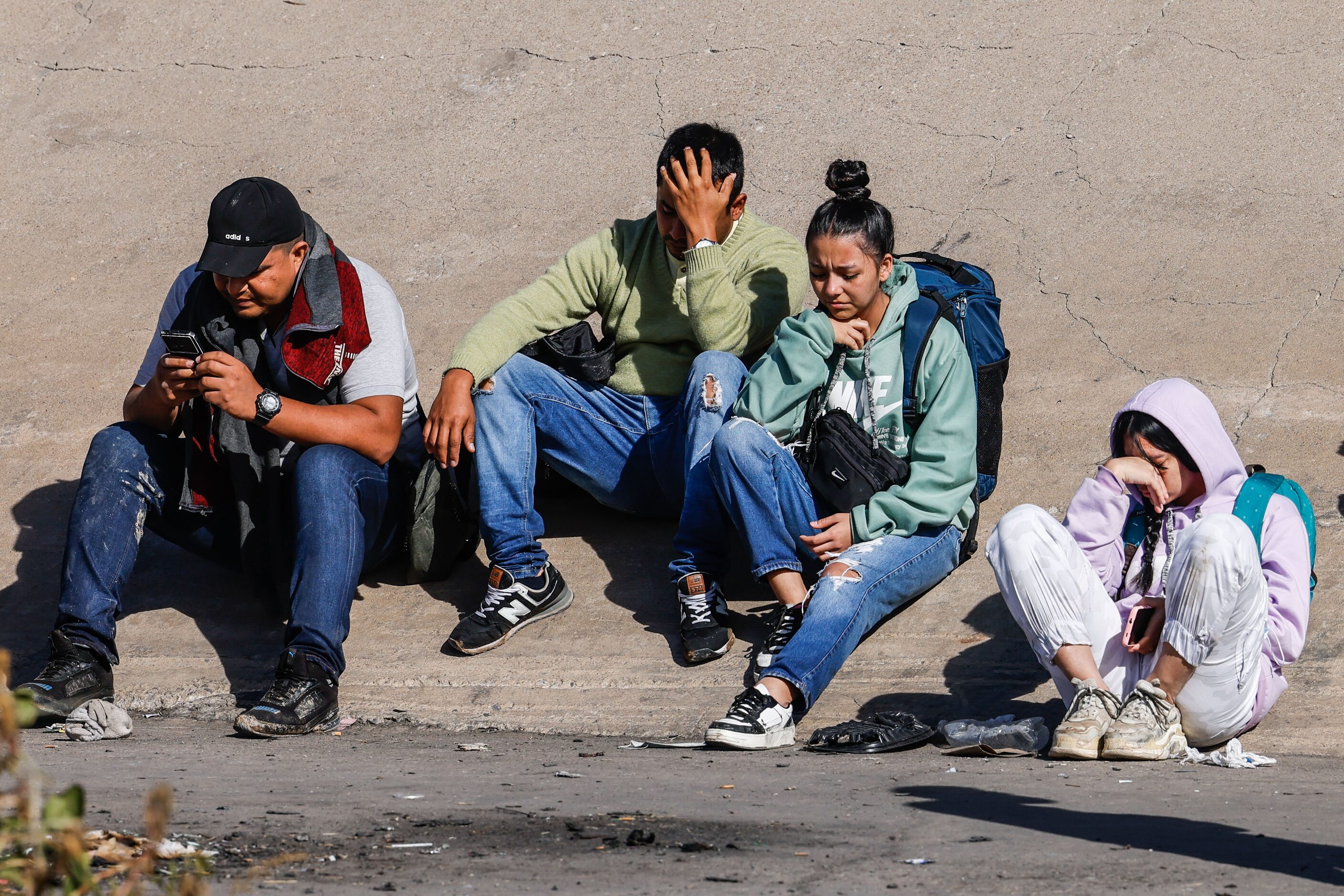 Migrants start to gather close to where the end of Texas National Guards are deployed at...