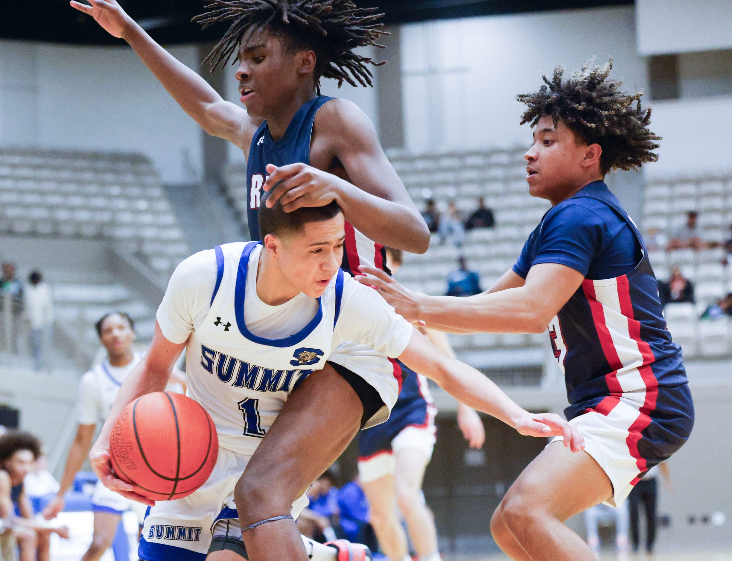 Mansfield Summit’s Theo Brannan (1) is fouled by Denton Ryan’s Kadon Jackson (back) as Mikah...