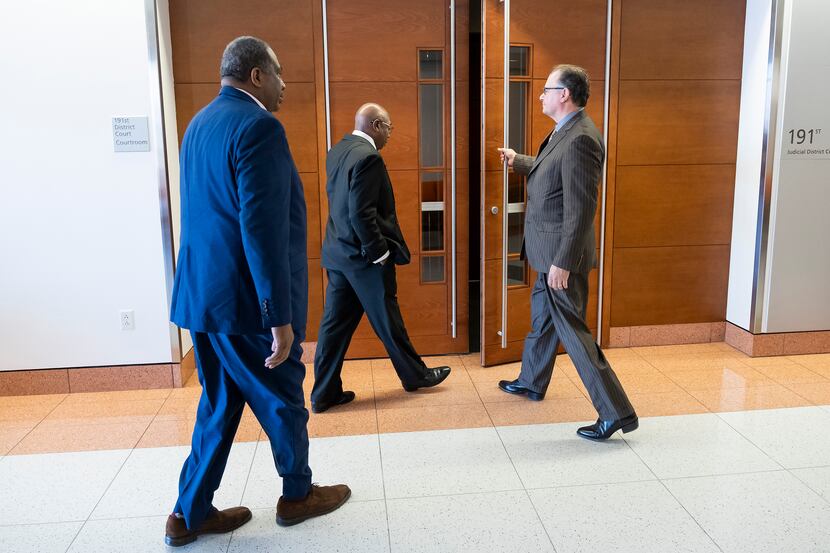 Chris Caso, then-interim city attorney, holds the door for Dallas Council Member Tennell...