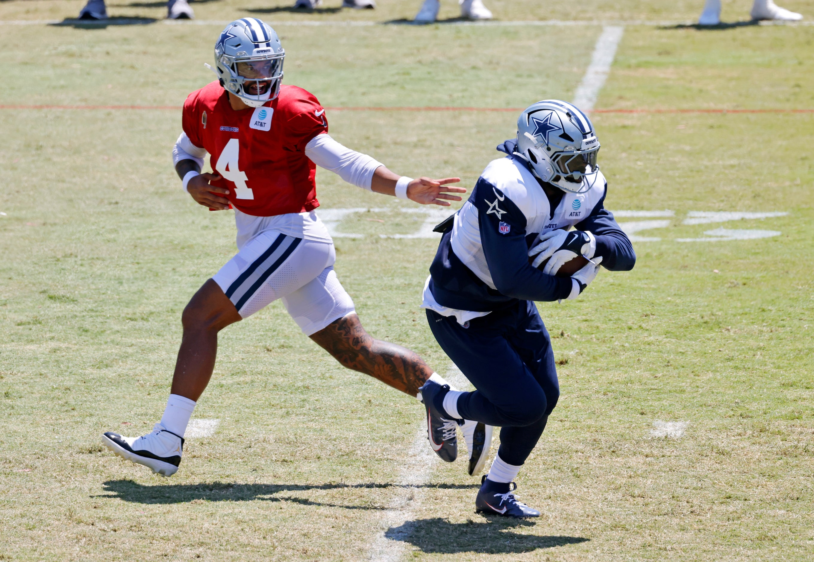 Dallas Cowboys quarterback Dak Prescott (4) hands the ball off to running back Ezekiel...