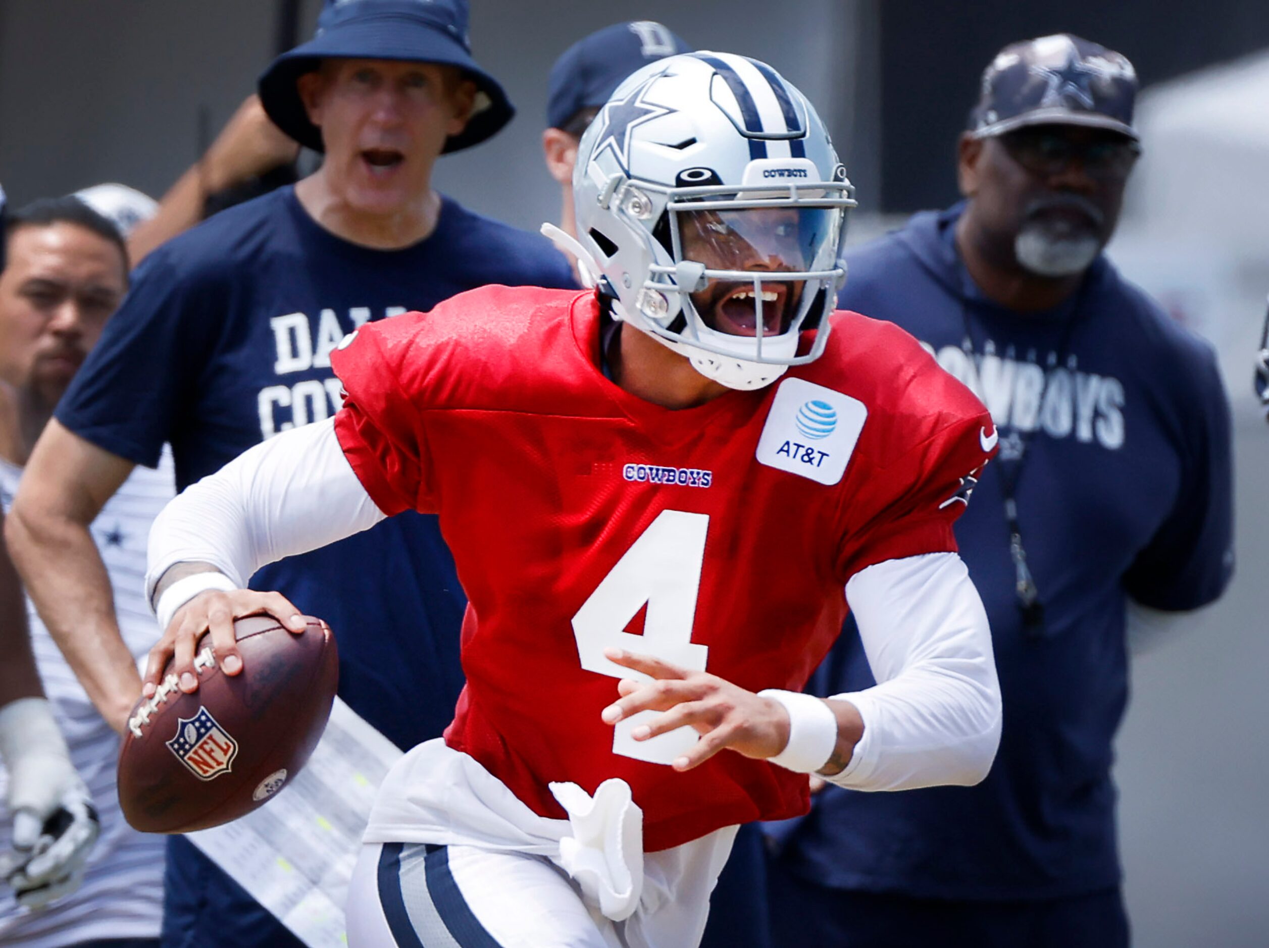 Dallas Cowboys quarterback Dak Prescott (4) scrambles to find a receiver during training...