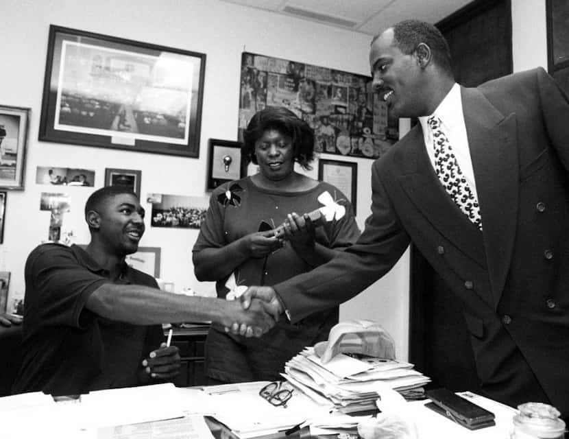 11-9-94 -- Lincoln High's Damion Walker, l,  shakes hands with Reginald Samples, athletic...