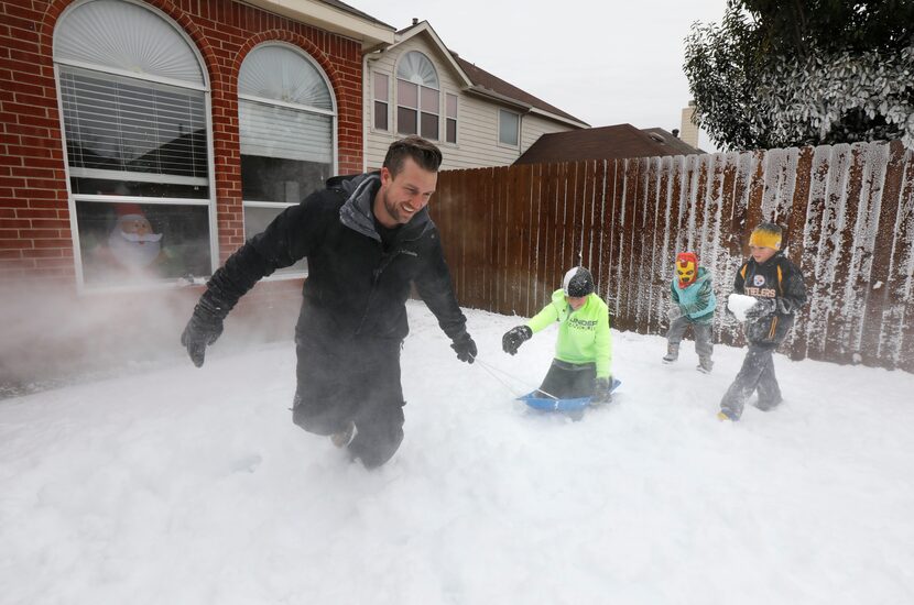 Jeramy Melchiorre, left, pulls his son, Jude Melchiorre, 12, as Emmaline Gibson, 6, his...