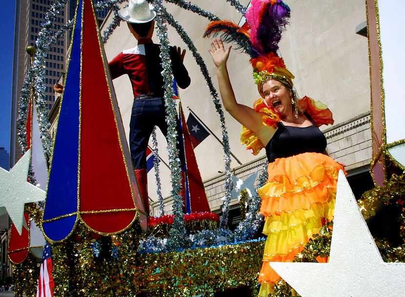 Dallas Morning News columnist Jacquielynn Floyd waves from the Big Tex float as the State...