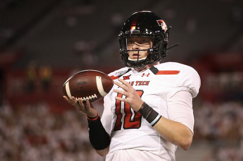Quarterback Alan Bowman of the Texas Tech Red Raiders warms up before the start of a game...