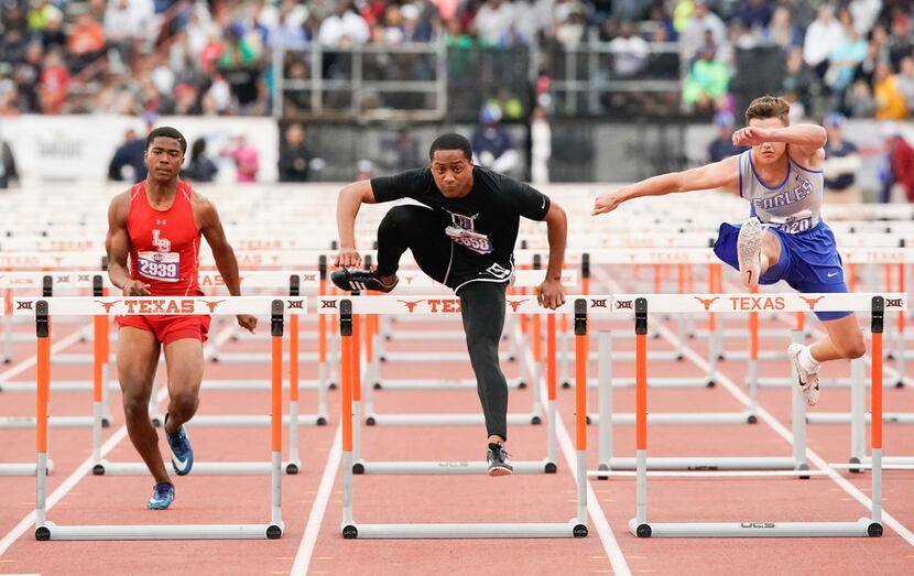 Terry Smith of Frisco Independence (center) clears the final hurdle to win the Class 5A boys...